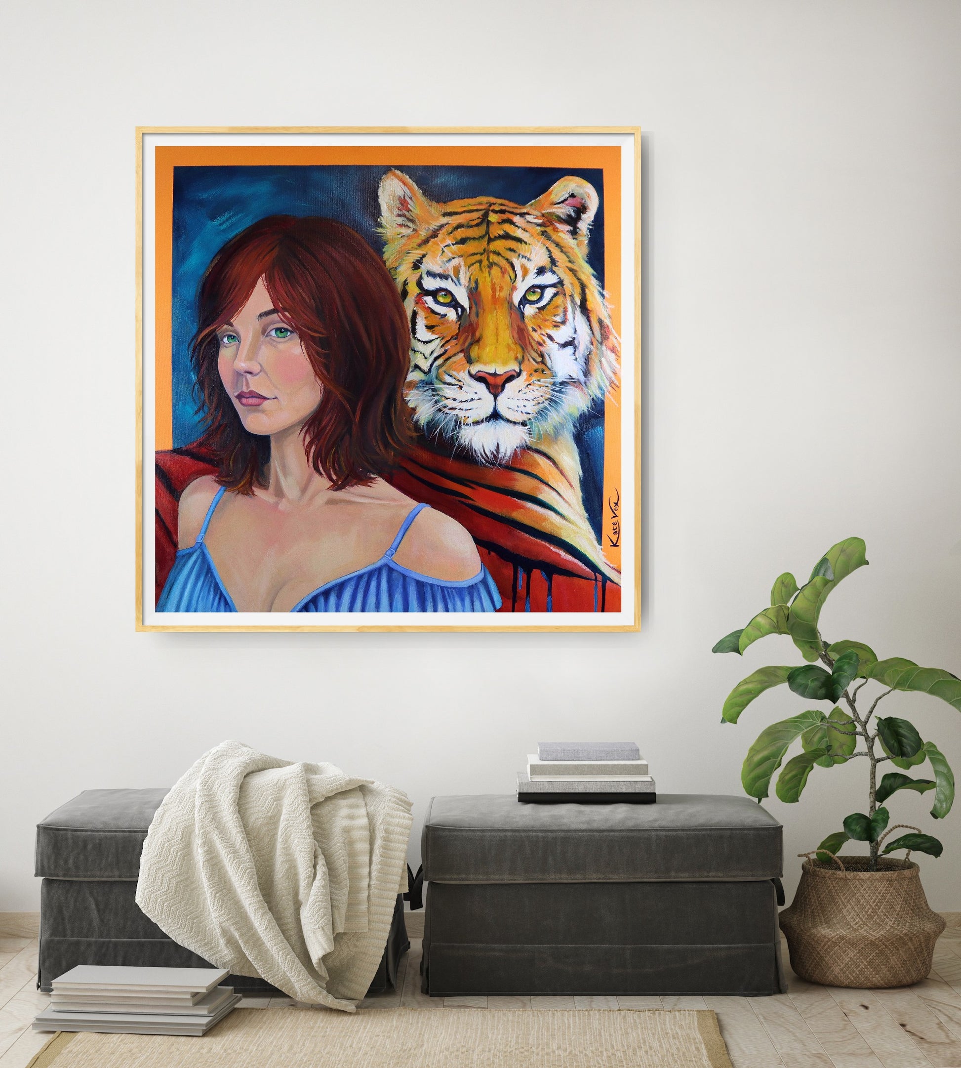 Framed artwork of a woman with a tiger on a wall in a living room.
